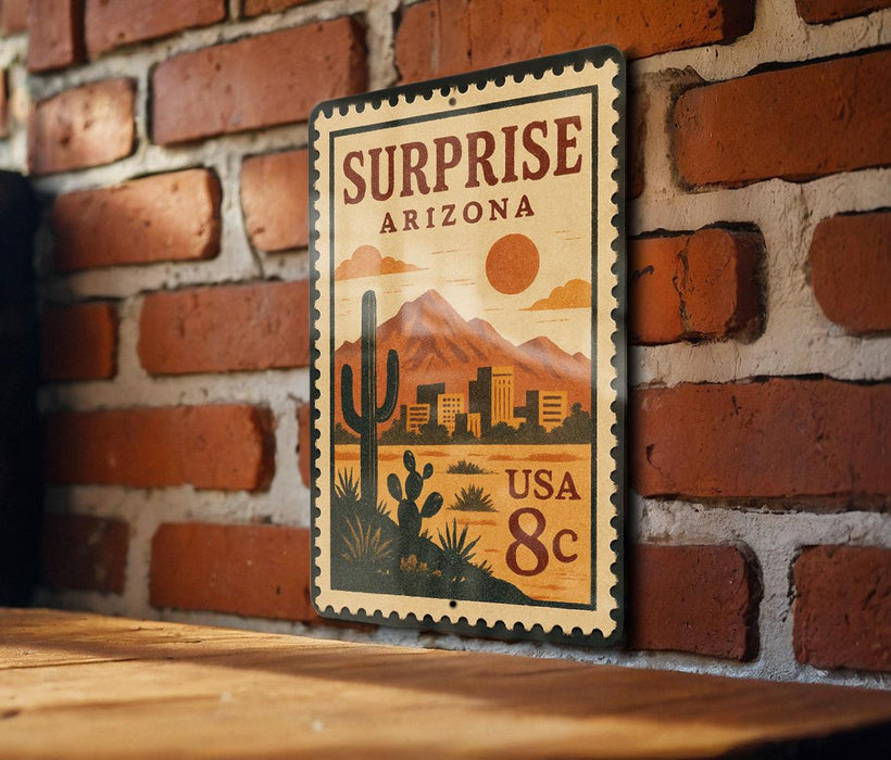 A vintage-style metal sign with a desert landscape and mountains, mounted on a brick wall.