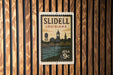 A vintage-style postage stamp from Louisiana, featuring a silhouette of the city skyline and water, is displayed on a wooden wall.