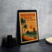 A framed stamp depicting Huntington Beach, California, with a palm tree and a pier in the background.