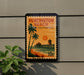 A postage stamp for Huntington Beach, California, featuring a palm tree and a pier against a sunset sky.