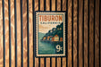 A postage stamp from Tiburon, California, featuring a scenic illustration of a coastal town with a pier and buildings.