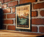 A vintage-style metal sign with the text "Eau Claire Wisconsin" displayed on a brick wall.