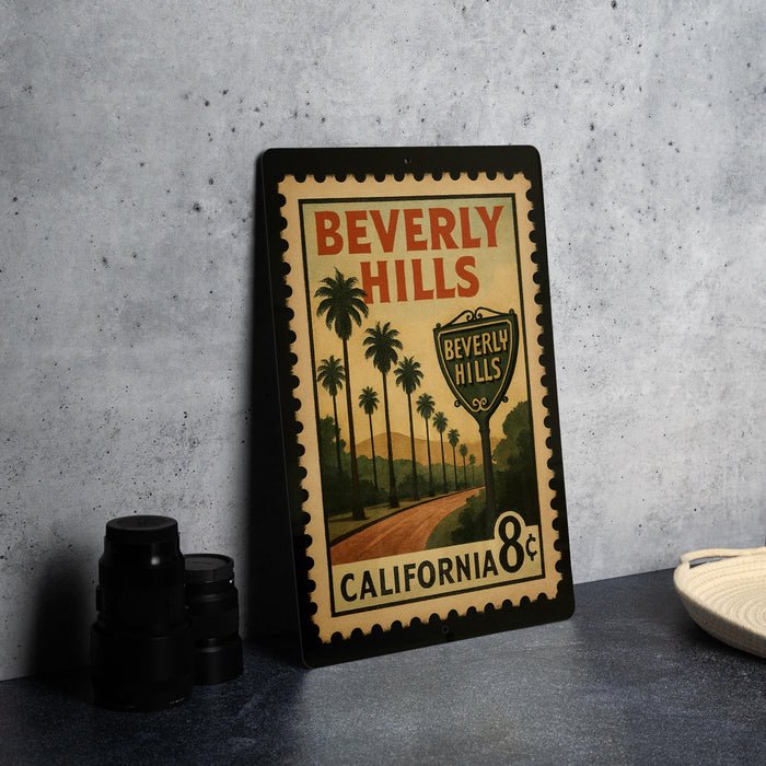 A vintage-style metal sign with the text "Beverly Hills" and "California 8¢" displayed on it, featuring a road and palm trees.