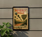 A vintage-style poster of Beverly Hills, California, featuring palm trees and a road, mounted on a wall.