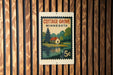 A vintage Minnesota postage stamp featuring a cottage and a lake, mounted on a wooden wall.
