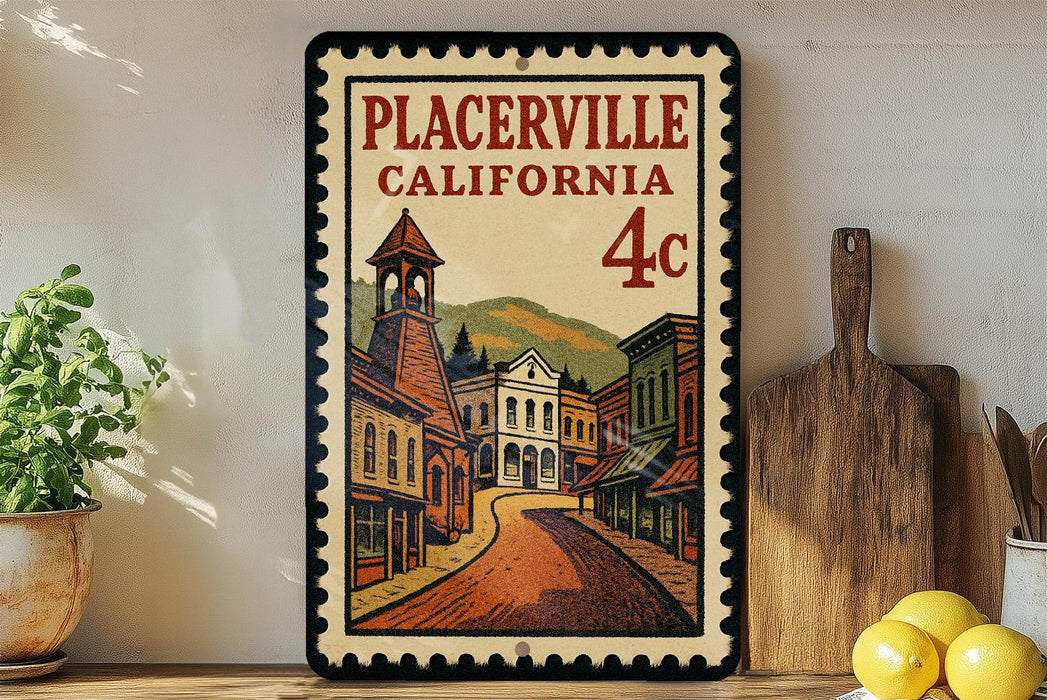 A framed vintage postage stamp depicting a street scene in Placerville, California, with a building and a bell tower.