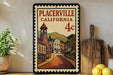 A framed vintage postage stamp depicting a street scene in Placerville, California, with a building and a bell tower.