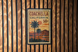 A vintage-style postage stamp from Coachella, California, featuring a palm tree and sunset landscape.