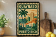 A vintage-style poster of Puerto Rico featuring palm trees and a cityscape, displayed on a wall next to a wooden cutting board and a potted plant.