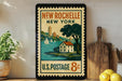 A vintage postage stamp from New Rochelle, New York, featuring a house and sailboats on a body of water.