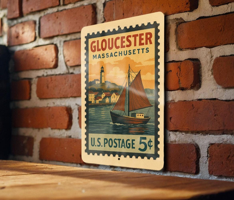 A vintage postage stamp from Gloucester, Massachusetts, featuring a sailboat on the water, mounted on a brick wall.