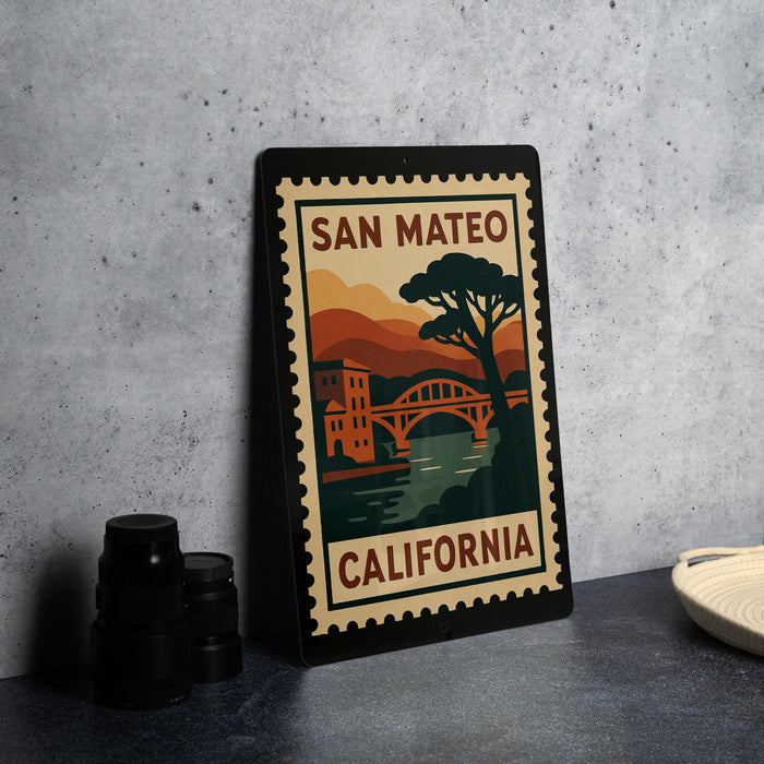 A framed poster of San Mateo, California, featuring a scenic illustration of the city and its landmarks, such as the bridge and the tree.
