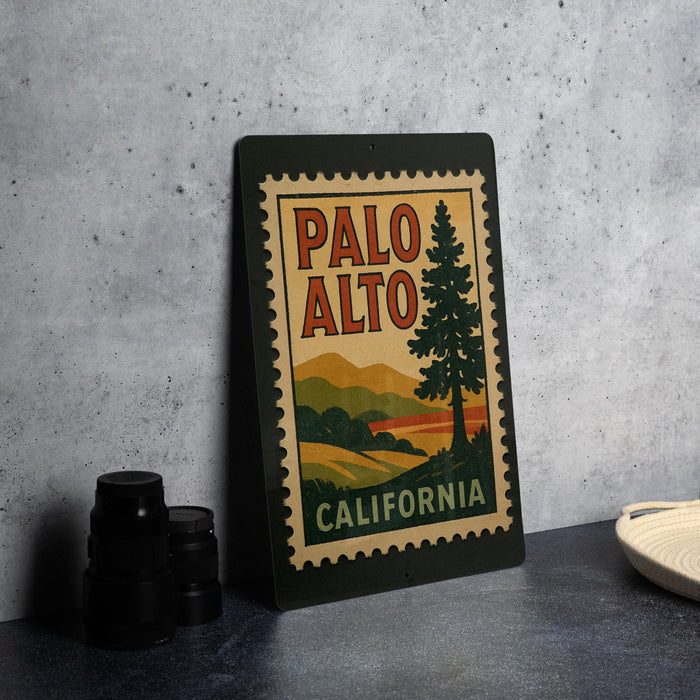 A framed vintage-style stamp with the text "PALO ALTO CALIFORNIA" is displayed on a table, along with some black camera lenses.
