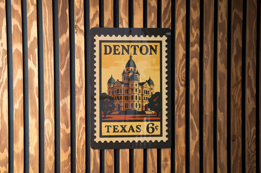 A vintage-style postage stamp from Texas, featuring a building with a dome, mounted on a wooden wall.