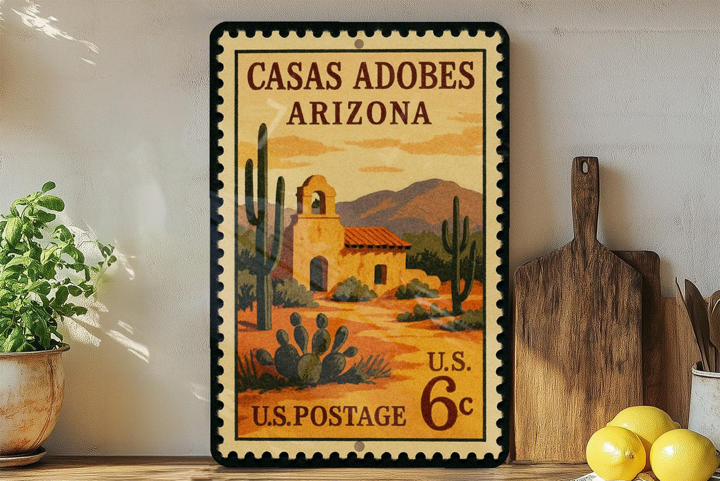 A vintage postage stamp depicting a desert scene with a building and cacti, placed on a shelf next to a wooden cutting board and a potted plant.