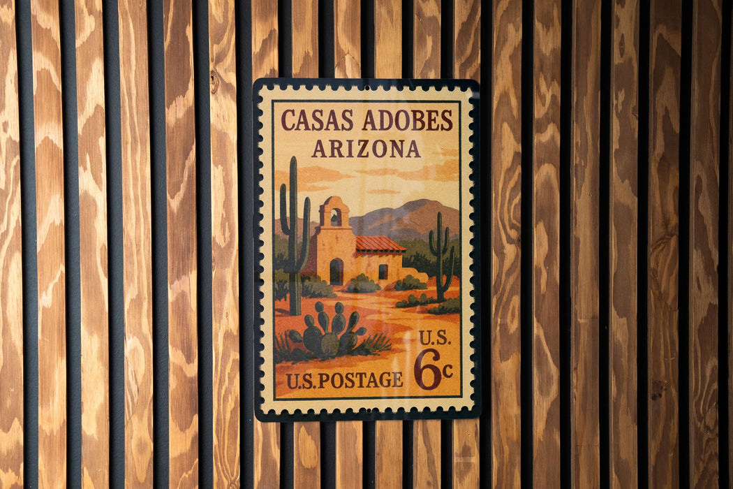 A U.S. postage stamp from Casas Adobes Arizona, featuring a desert landscape with a bell tower and cacti.