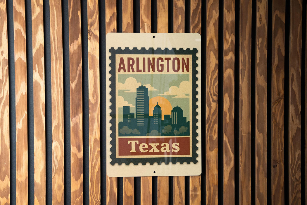 A vintage-style metal sign with the text "ARLINGTON TEXAS" displayed on it, mounted on a wooden wall.