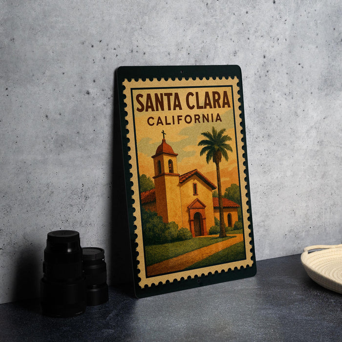 A framed poster of Santa Clara, California, featuring a church and palm trees, is displayed on a countertop.