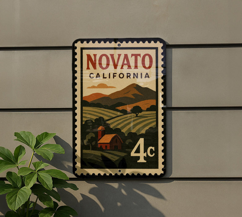 a vintage-style postage stamp with a landscape scene and a red barn, mounted on a wall.