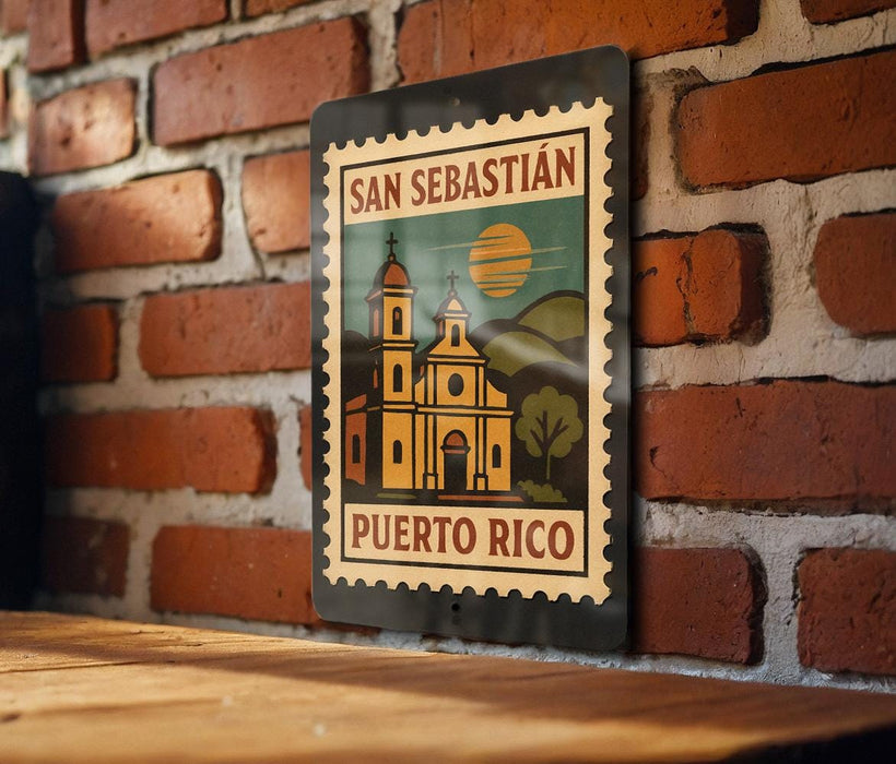 A metal sign with a vintage-style illustration of a church and mountains, mounted on a brick wall.