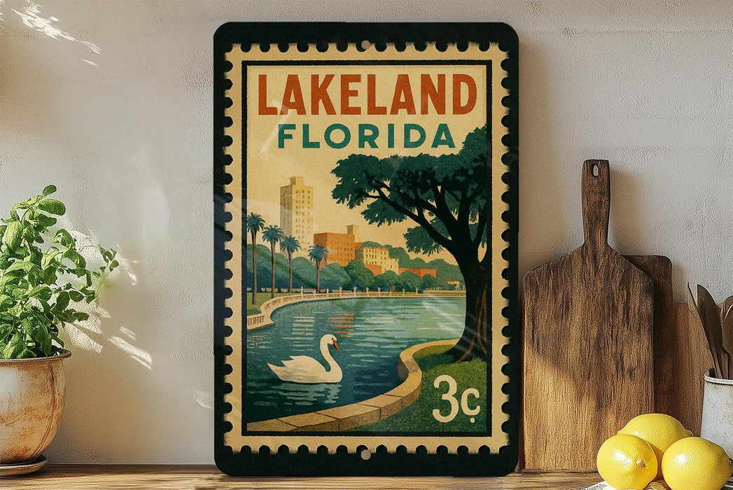 A framed vintage-style poster of Lakeland, Florida, featuring a swan in a pond and palm trees, is displayed on a shelf next to a wooden cutting board and a potted plant.