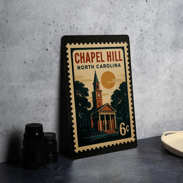 A metal poster or sign displaying the name "Chapel Hill North Carolina" and a depiction of a church, with a 6-cent value.