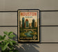 A vintage postage stamp from the United States, featuring an illustration of the Houston skyline and a river, mounted on a wall.