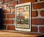 A vintage-style postage stamp from Minnesota, featuring an illustration of an apple tree with three apples, mounted on a brick wall.