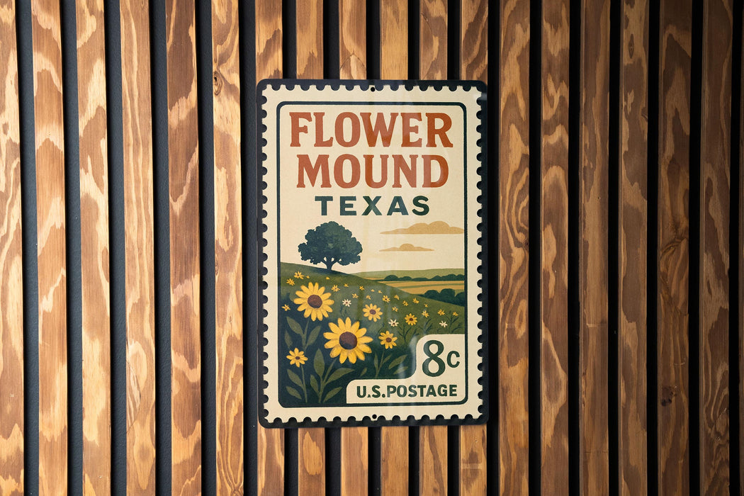 A vintage-style metal sign with a floral design and text, mounted on a wooden wall.