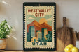 A framed poster of West Valley City, Utah, featuring a mountain landscape and cityscape.