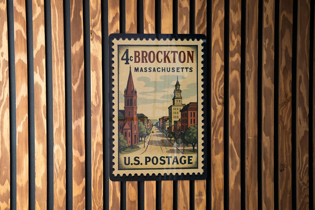 A vintage postage stamp from the United States of America, featuring a cityscape and a church, is displayed on a wooden wall.