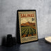 A metal stamp with a vintage-style illustration of a farm landscape and mountains, depicting the state of California.