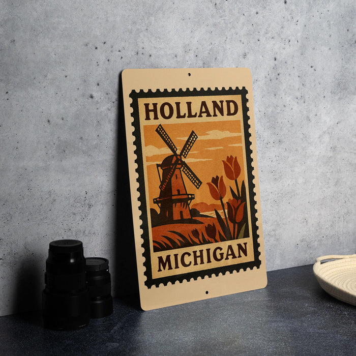 A metal sign with a vintage-style illustration of a windmill and tulips, along with the text "Holland Michigan", is displayed on a table.