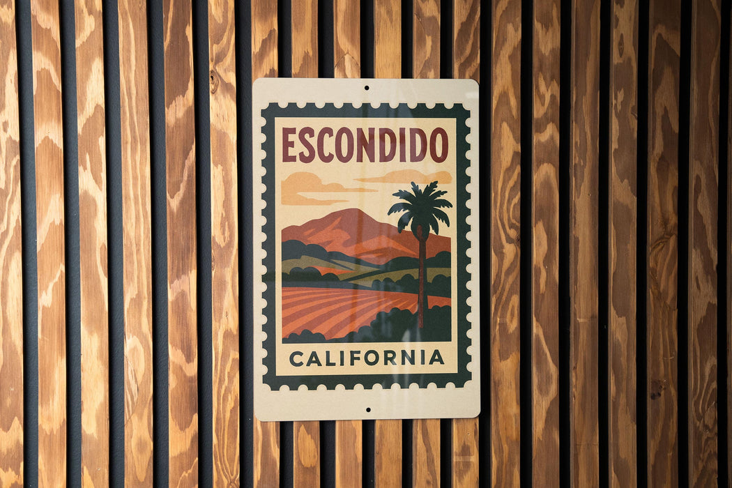 A metal sign with a vintage-style illustration of a palm tree and a landscape, mounted on a wooden wall.