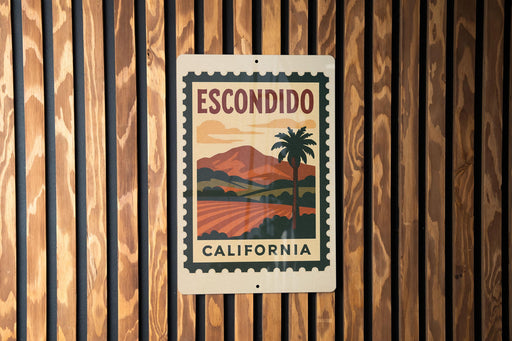 A metal sign with a vintage-style illustration of a palm tree and a landscape, mounted on a wooden wall.