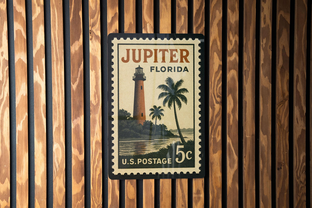 A vintage postage stamp from Jupiter, Florida, featuring a lighthouse and palm trees.