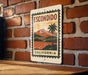 A vintage-style metal sign with the text "ESCONDIDO CALIFORNIA" displayed on a brick wall.