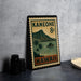 A vintage-style postage stamp from Hawaii, featuring a mountain landscape and palm trees, is displayed on a countertop next to some black camera lenses.