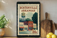 A vintage postage stamp from Bentonville, Arkansas, featuring a water tower and a small town scene.