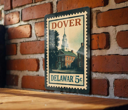 A vintage-style metal stamp depicting a building with a clock tower, mounted on a brick wall.