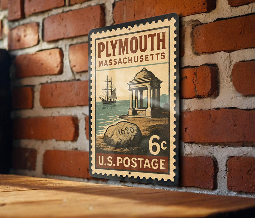 A vintage-style postage stamp from Plymouth, Massachusetts, featuring a ship and a building, is displayed on a brick wall.