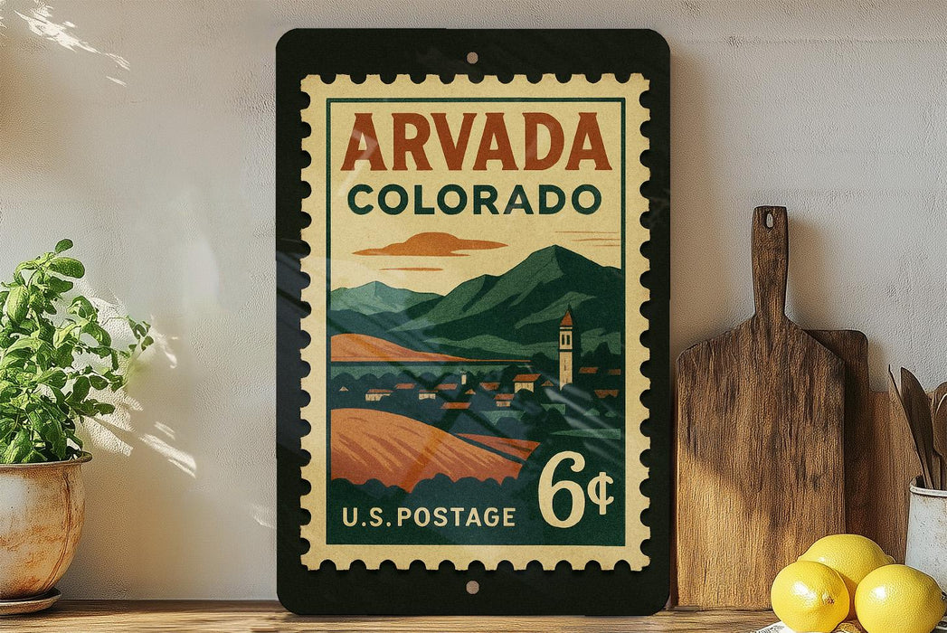 A vintage-style postage stamp from the United States of America, featuring a scenic mountain landscape and a small town, displayed on a shelf next to a wooden cutting board and some lemons.