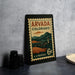 A vintage postage stamp from the United States of America, featuring a scenic landscape of mountains and a small town, with the text "ARVADA COLORADO" and "6¢ U.S. POSTAGE".