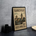 A vintage postage stamp from Georgia, featuring a cityscape and a clock tower, is displayed on a table.