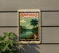 A vintage-style postage stamp depicting a tropical landscape with palm trees, a river, and a cloudy sky, mounted on a wall.
