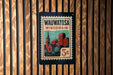 A vintage-style postage stamp from Wisconsin, featuring a cityscape and the text "Wauwatosa Wisconsin" on it.