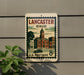 A vintage postage stamp from the United States, featuring an illustration of a town with a clock tower, hanging on a wall.