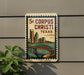 A decorative sign with a cityscape and a bridge, mounted on a wall.