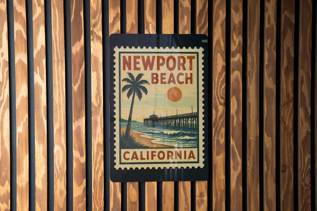 A vintage-style poster of Newport Beach, California, featuring a palm tree and a pier, is displayed on a wooden wall.