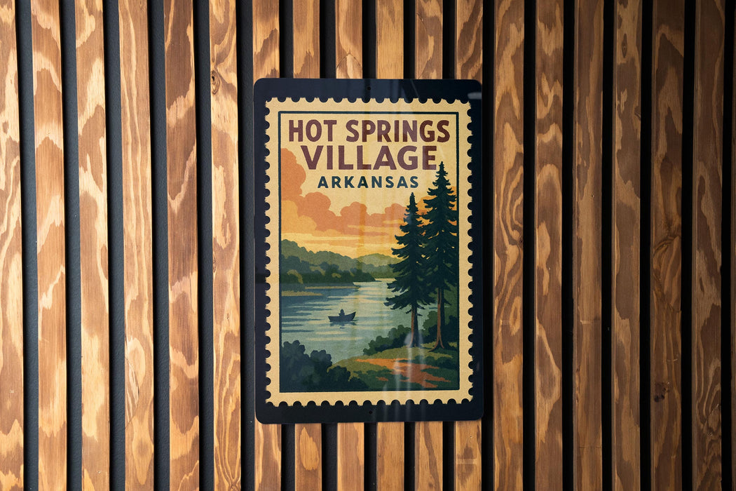 A vintage-style postage stamp depicting a scenic landscape with a river, pine trees, and a small boat, hanging on a wooden wall.